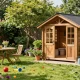 Ein wunderschönes Gartenhaus aus Holz umgeben von blühenden Pflanzen und einer einladenden Gartenlandschaft.